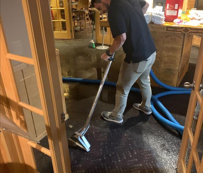 water technician extracting restaurant carpet  