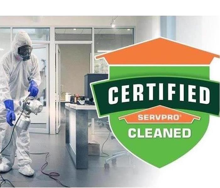 SERVPRO logo with technician performing COVID clean 